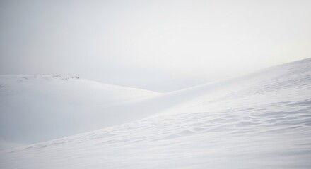 Serene Snowy Landscape With Gentle Rolling Hills Under A Pale Winter Sky