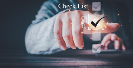AI assisted checklist concept. A hand points to a glowing checkmark on a digital checklist interface, with a small robot icon, signifying task completion or verification.