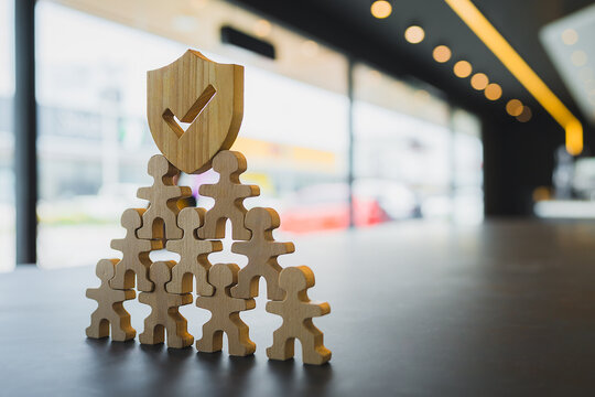 Shield icon and people model. Security protection and group  insurance. The concept of family home, protection, health care day, car insurance.