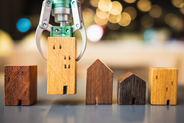 A robot lifting a house model, among others on a table, illustrates AI-powered real estate selection for optimized profit and minimized risk.