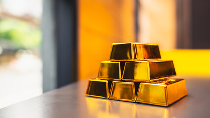Gold bars rest on a company employee's desk, symbolizing the sound investment strategy of saving in gold.