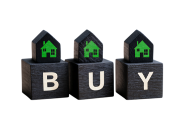 Black wooden cubes with green houses on top, the words "BUY" written in white letters, isolated on a plain background.