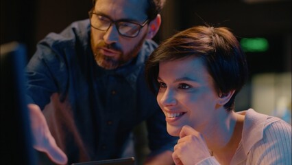 Business woman man working in night evening office mentor assistant co-workers online computer...