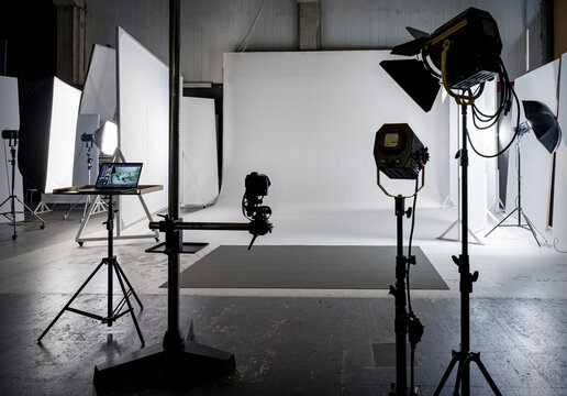 Interior of a photography studio, with lights and white backdrop