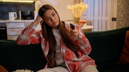 Bored tired upset girl Caucasian woman alone watching television at home evening night insomnia...