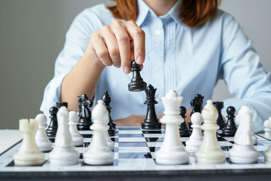 hand of businesswoman moving chess in competition shows leadership, followers and business success strategies