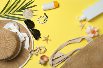 Tropical vibes shot from above. Straw hat, sunglasses, pineapple, wicker bag, beach accessories on...