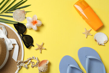 Tropical vibes shot from above. Straw hat, sunglasses, pineapple, wicker bag, beach accessories on...