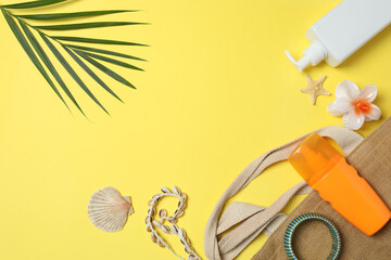 Tropical vibes shot from above. Straw hat, sunglasses, pineapple, wicker bag, beach accessories on...