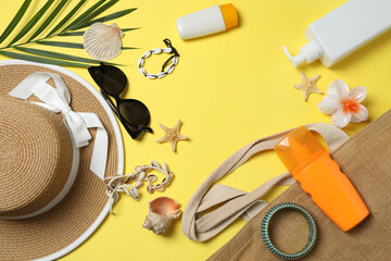 Tropical vibes shot from above. Straw hat, sunglasses, pineapple, wicker bag, beach accessories on...
