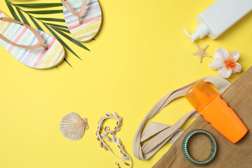 Tropical vibes shot from above. Straw hat, sunglasses, pineapple, wicker bag, beach accessories on...