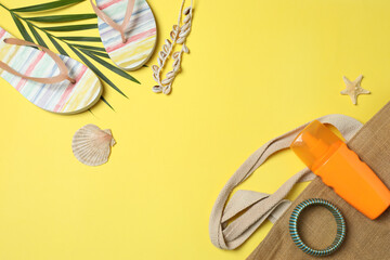 Tropical vibes shot from above. Straw hat, sunglasses, pineapple, wicker bag, beach accessories on...