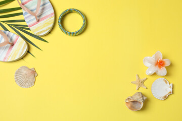 Tropical vibes shot from above. Straw hat, sunglasses, pineapple, wicker bag, beach accessories on...