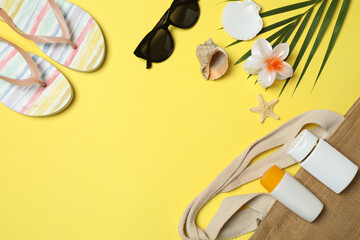 Tropical vibes shot from above. Straw hat, sunglasses, pineapple, wicker bag, beach accessories on...