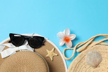 Tropical vibes shot from above. Straw hat, sunglasses, pineapple, wicker bag, beach accessories on...
