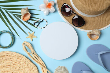Tropical vibes shot from above. Straw hat, sunglasses, pineapple, wicker bag, beach accessories on...