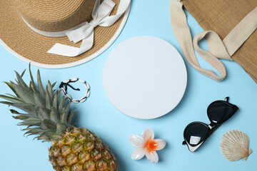 Tropical vibes shot from above. Straw hat, sunglasses, pineapple, wicker bag, beach accessories on...