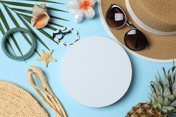 Tropical vibes shot from above. Straw hat, sunglasses, pineapple, wicker bag, beach accessories on...