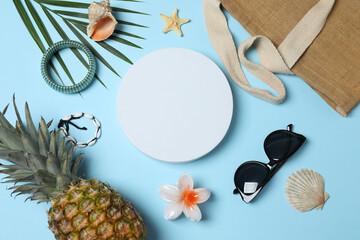 Tropical vibes shot from above. Straw hat, sunglasses, pineapple, wicker bag, beach accessories on...