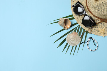 Tropical vibes shot from above. Straw hat, sunglasses, pineapple, wicker bag, beach accessories on...