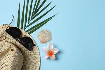 Tropical vibes shot from above. Straw hat, sunglasses, pineapple, wicker bag, beach accessories on...
