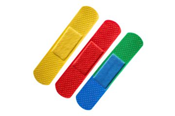 A close up of three colorful adhesive bandages arranged diagonally on a black background surface