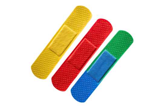 A close up of three colorful adhesive bandages arranged diagonally on a black background surface