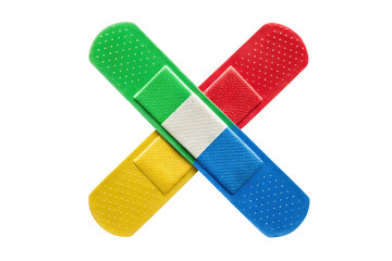 Colorful adhesive bandages in a criss cross pattern on a plain black background studio shot