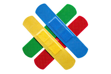 Close up of four colorful adhesive bandages overlapping on a black background studio shot