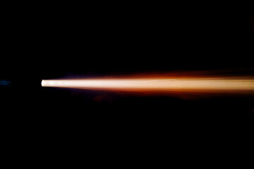 A shot from a firearm on a black background. flame from a jet engine.