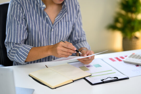 Young entrepreneur checking business data at home workspace