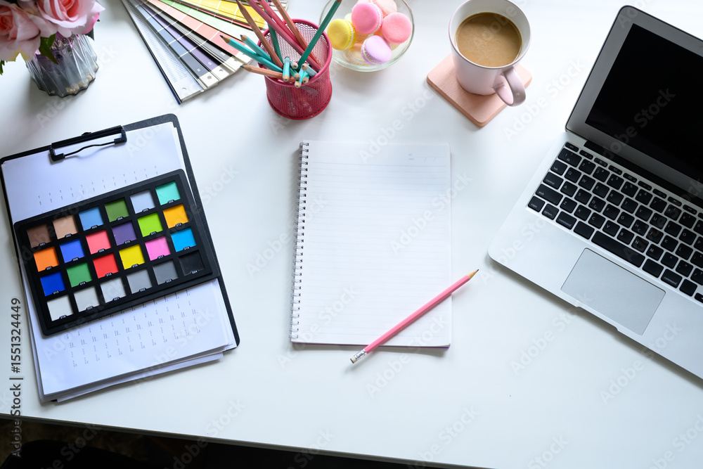 Poster overhead view of creative graphic designer workspace with laptop and color palette tools