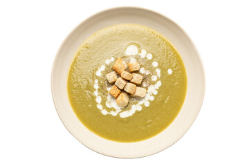 Zucchini, onion and potato soup served on beige dish no background cutout
