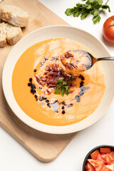 Hand taking a scoup of salmorejo, Spanish traditional food.