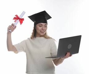 Happy student with diploma and laptop after graduation on white background