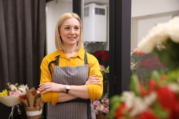 Business owner with crossed arms in her flower shop