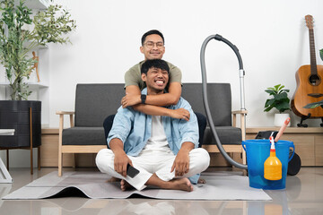 Happy Couple Embracing While Cleaning. Loving interaction during household chores.