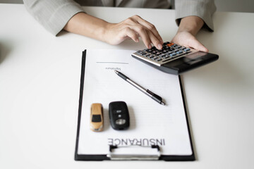 Fototapeta premium The hands of the real estate agent draw up an agreement, contractual documents on car loans