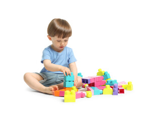 Cute little boy playing with building bricks on white background