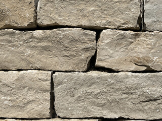 Textured stone background with irregularly shaped gray stones arranged in a pattern. 