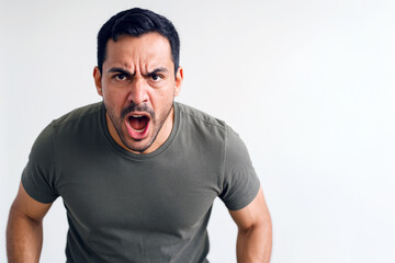 Portrait of an angry Latino man shouting with an intense, aggressive expression and dynamic posture, clearly showing the choleric temperament.
