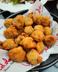 Close-up of fried breaded olives served as a traditional Spanish tapas dish. Golden, crispy texture, perfect as a savory appetizer or snack.
