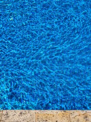 blue water in swimming pool with water. swimming pool with blue water and sun reflections 