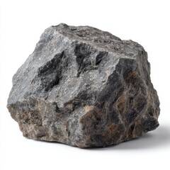 Fototapeta premium A rugged textured dark gray igneous rock with hints of brown and white specks sits on a white background