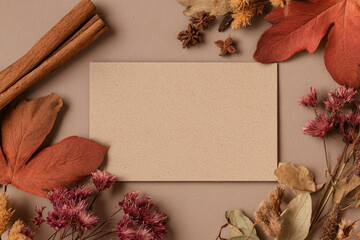 Autumn themed mockup with a background for lettering and text input on kraft paper, surrounded by autumn leaves	