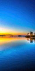 Obraz premium A serene landscape of a peaceful lake at sunset on a clear sky blue background