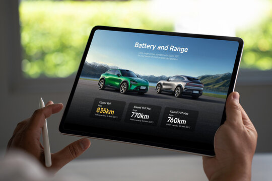 Customer browsing xiaomi yu7 electric car models on tablet with stylus