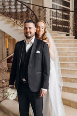 The bride and groom are on a beautiful staircase.