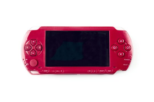 Neu-Ulm, Germany - June, 25, 2025:  Red Playstation PSP handheld game system on a white background. 