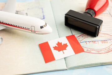 Canada flag with passport and airplane for travel.